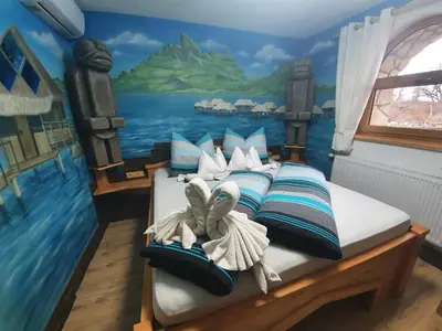 a bedroom with a bed with a painting on the wall at Resort Svět in Úžice
