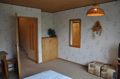 a room with a bedroom with a door and a mirror at Pension Nostalgie in Beroun