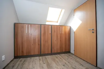 a room with wooden doors and a window at Hotel U koně in Beroun