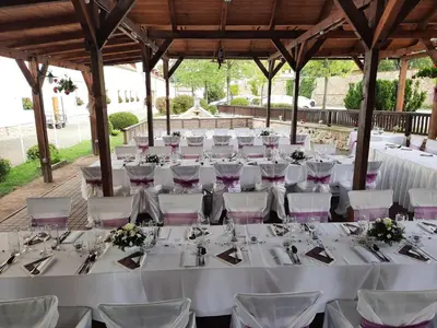 a table set up for a wedding with white tables and chairs at Hotel Čertousy in Prague