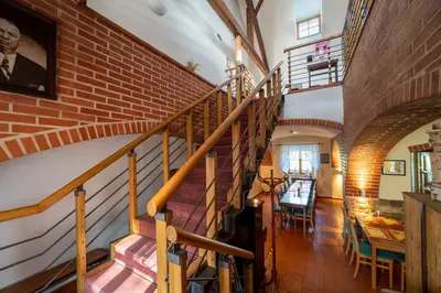 a staircase in a house with a brick wall at Hotel Čertousy in Prague