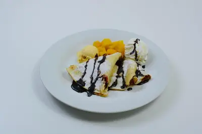 a white plate with food on a white table at Hotel ILF in Prague