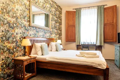 a bedroom with a bed with a flowery wall at Residence Hattrick in Prague