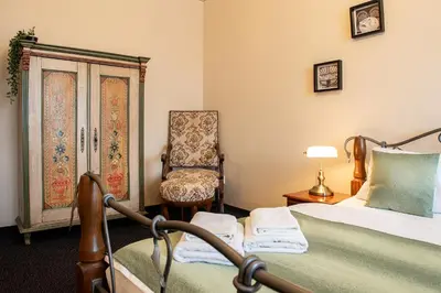 a bedroom with a bed and a chair at Residence Hattrick in Prague