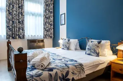 a bedroom with a bed with blue walls at Residence Hattrick in Prague