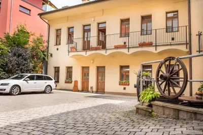 a white car parked in front of a building at Residence Hattrick in Prague