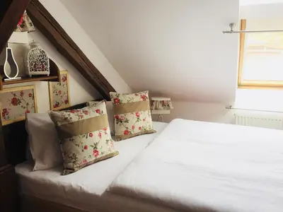 a bedroom with a white bed with pillows and a window at Residence Hattrick in Prague
