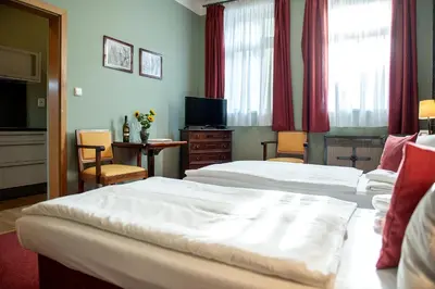 a hotel room with two beds and a television at Residence Hattrick in Prague