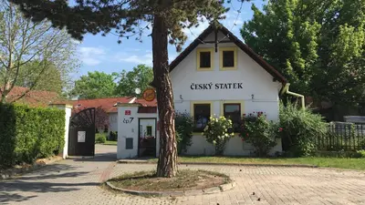 a white building with a sign that reads guest starter at Český Statek in Prague