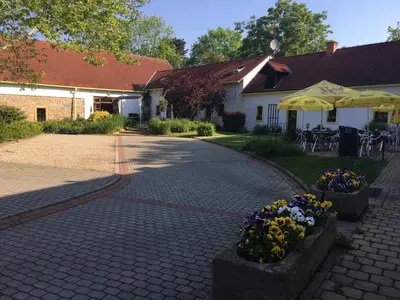 a brick walkway with flowers in front of a building at Český Statek in Prague
