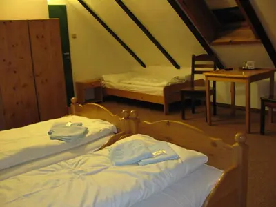 a bedroom with two beds and a table and chairs at Český Statek in Prague