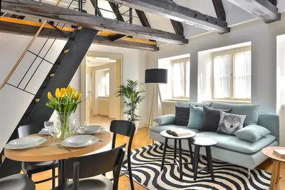 a living room with a couch and a table at U Kapra Apartments in Prague