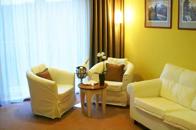 a living room with two chairs and a table at Dolce Villa in Prague