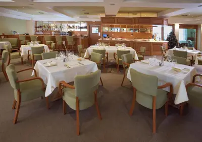 a dining room with white tables and chairs at Dolce Villa in Prague