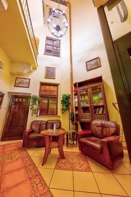 a living room with two couches and a table at Betlem Club Hotel in Prague