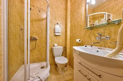 a bathroom with a toilet and a sink and a shower at Betlem Club Hotel in Prague