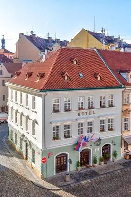 a large white building with a red roof at Betlem Club Hotel in Prague