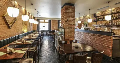 a restaurant with tables and chairs and a bar at Rozmaryn Hotel B&B in Rakovník