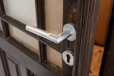a door handle on a door with a window at Apartments in Mala Strana - 10 minutes from Charles Bridge in Prague