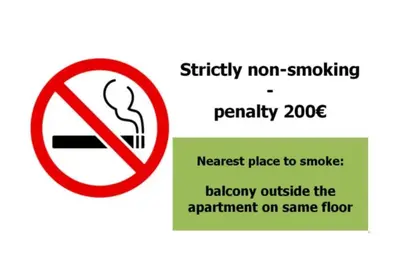 a sign that reads strictly not smoking penalty zone nearest place to smoke balcony outside at Apartments in Mala Strana - 10 minutes from Charles Bridge in Prague