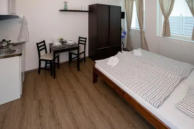 a bedroom with a bed and a table with chairs at Žižkov Cosy Studio Apartments in Prague
