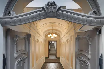 an archway in a hallway with a staircase at Louren Apartments in Prague