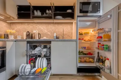 a kitchen with an open refrigerator filled with food at Louren Apartments in Prague