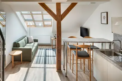 a kitchen and living room with a couch and a table at Louren Apartments in Prague