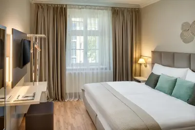 a hotel room with a bed and a window at Louren Apartments in Prague