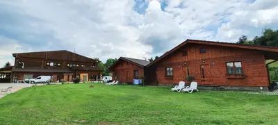 a house with a yard with chairs in front of it at Sport-hotel Šibeniční vrch in Mnichovice