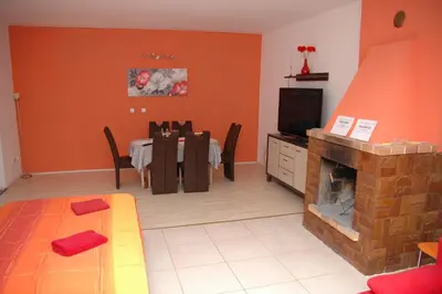 a room with a table with red roses on it at Penzion V Roklich & Apartments V Roklich in Ricany
