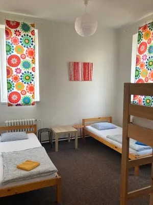 a room with two beds and two windows at Hostel Praha Ládví in Prague