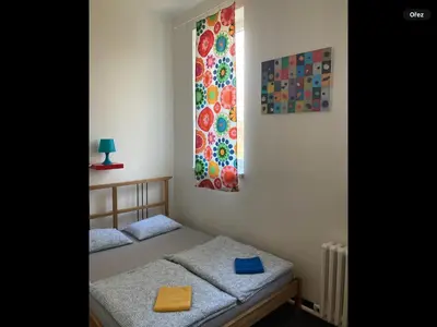 a bedroom with two twin beds and a window at Hostel Praha Ládví in Prague