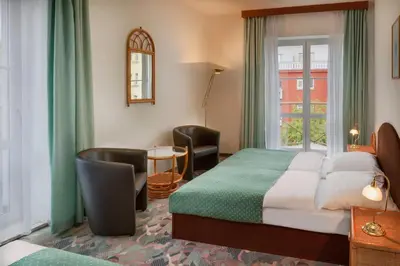 a hotel room with a bed and a window at Hotel Otar in Prague