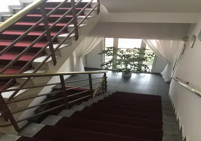 a staircase in a house with a stair case at Hotel Otar in Prague