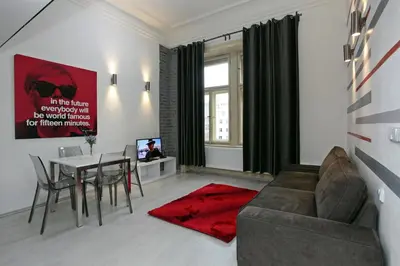 a living room with a couch and a table at Apartment House - The Modern Flat in Prague