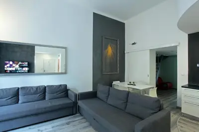 a living room with a couch and a table at Apartment House - The Modern Flat in Prague