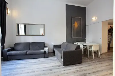 a living room with a couch and a chair and a table at Apartment House - The Modern Flat in Prague