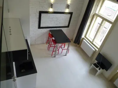 a room with a table and red chairs in it at Apartment House - The Modern Flat in Prague