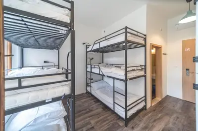 two bunk beds in a dorm room with wood floors at Hostel Orange in Prague
