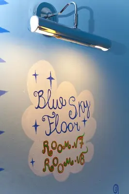 a light with a blue sky showroomroom sign on a cloud at Hostel Orange in Prague
