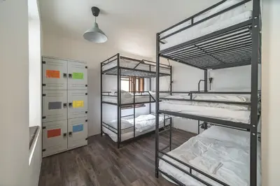 a room with three bunk beds in it at Hostel Orange in Prague