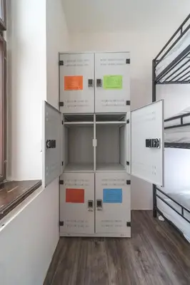 a room with white lockers in a room at Hostel Orange in Prague