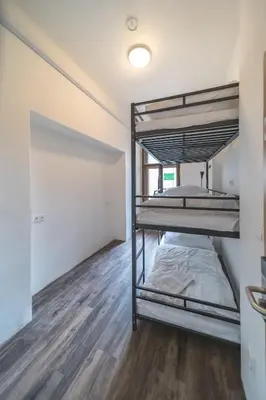 a bedroom with two bunk beds in a room at Hostel Orange in Prague