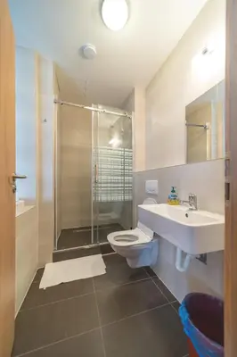 a bathroom with a sink and a toilet and a shower at Hostel Orange in Prague