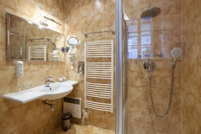 a bathroom with a sink and a shower at Tyn Yard Residence in Prague