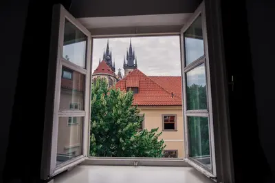 an open window with a view of a city at Tyn Yard Residence in Prague