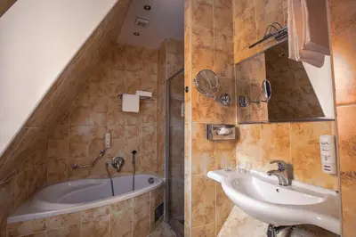 a bathroom with a tub and a sink at Tyn Yard Residence in Prague