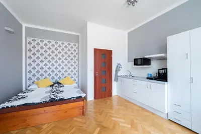 a bedroom with a bed and a kitchen at Modern apartment few steps from centre in Prague