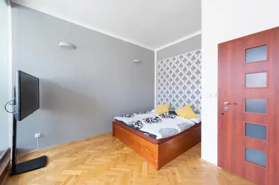 a bedroom with a bed and a tv and a door at Modern apartment few steps from centre in Prague